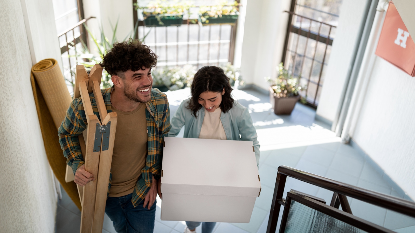 a young couple moving into their new apartment